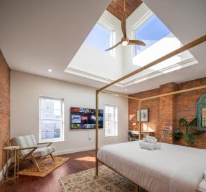 a bedroom with a large bed and a skylight at Your Perch at University City in Philadelphia