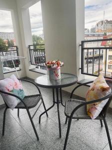 a balcony with a table and two chairs and a table at Апартаменты COMFORT в жк Империал in Truskavets