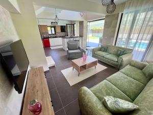 a living room with a couch and a table at Göcek Villa Hayal in İnlice