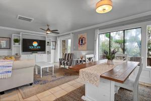 a living room with a couch and a table at The Waterway 405 by Sea Scape Properties in Wrightsville Beach