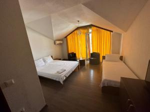 a small room with two beds and a window at Murtishi Apartment in Struga