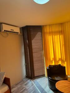 a living room with a window and a chair at Murtishi Apartment in Struga +23 photos