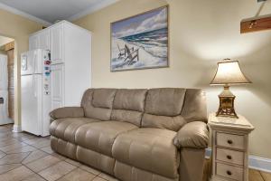a living room with a couch and a table with a lamp at The Waterway 403 by Sea Scape Properties in Wrightsville Beach
