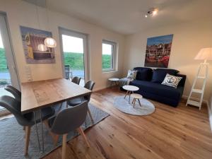 a living room with a couch and a table at Ferienwohnung-Frees-Mooi in Neßmersiel