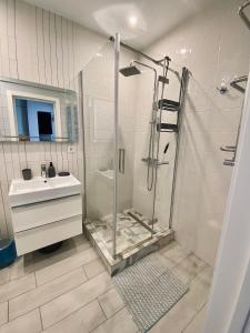 a bathroom with a shower and a sink at Апартаменты COMFORT в жк Империал in Truskavets