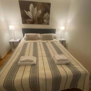 a bedroom with a large bed with two towels on it at Strandis in Mariehamn