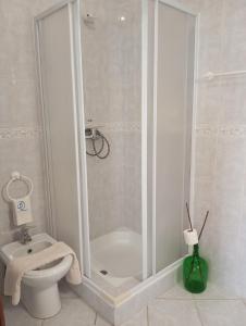 a bathroom with a shower with a toilet and a sink at Casa Dunas in São Jacinto +54 photos