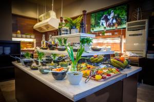a buffet line with a lot of fruits and vegetables at Hotel Orlovetz in Pamporovo