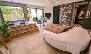 a bedroom with a large bed and a sink at Les Suites du Payré - Suite Romance in Saint-Hilaire-de-Talmont +64 photos
