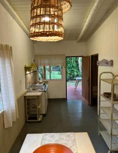 a kitchen with a chandelier and a room with a table at La casita de CristAl in Puerto Rico