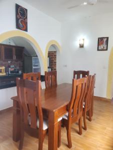 a dining room with a wooden table and chairs at Muna Beachfront Apartment in Malindi