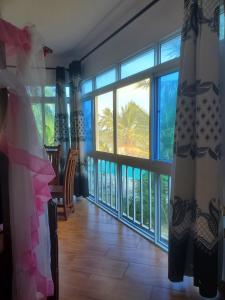 a bride in a wedding dress standing in front of a window at Muna Beachfront Apartment in Malindi
