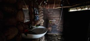 a stone bathroom with a sink and a toilet at Tanna Lava View Bungalows in Lénakel