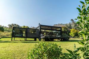 a house that is sitting in the grass at Casa Satori in Suesca +27 photos