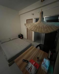 a bedroom with a bed and a table with a book at Ghoreo in Bādda