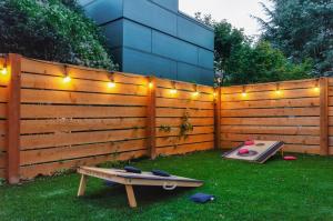 a fence with lights and a ping pong table at Travelers Dream, Walk to Space Needle, Firepit, cornhole in Seattle