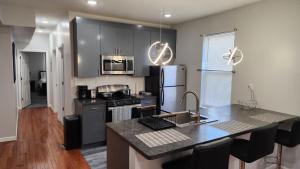 a kitchen with a counter top and a refrigerator at Comfortable Apartment in Irvington