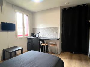 a small kitchen with a sink and a counter at Résidence des Carmes in Dol-de-Bretagne