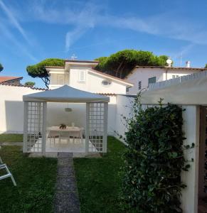 a white gazebo with a table in a yard at MINZONI94 - TwoBedroom+Garden in Lido di Camaiore