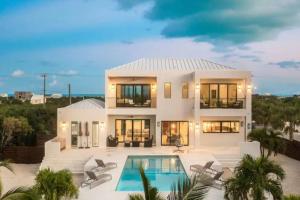 a large white house with a swimming pool at Villas private pool Long Bay Hills, Turks and Caicos Islands in Long Bay Hills