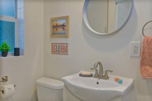 a white bathroom with a sink and a mirror at 2 MI to DT Orlando & Winter Park in Orlando