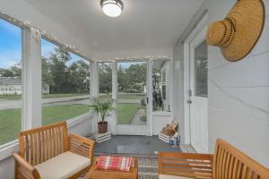a screened in porch with two chairs and a table at 2 MI to DT Orlando & Winter Park in Orlando