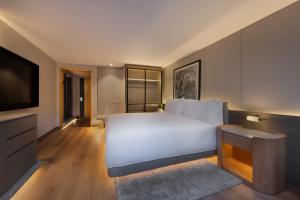 Postel nebo postele na pokoji v ubytování JW Marriott Auckland