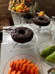 a table with a chocolate cake and carrots and fruit at Mansão Mascarenhas in Lençóis +52 photos