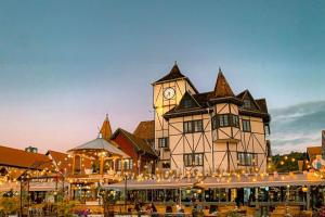 a large building with a clock tower on top of it at Quartos próximos à Oktoberfest, em Blumenau in Blumenau