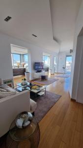 a living room with a couch and a table at Attico Reale - in Centro, tra Stazione e Bari Vecchia in Bari