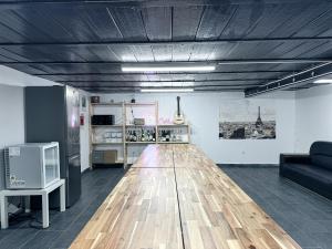 a living room with a wooden floor and a couch at C'est La Vie Korean Style Minbak PARIS in Bagnolet