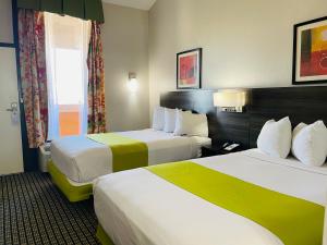 a hotel room with two beds and a window at SureStay by Best Western Irving Grapevine DFW North in Irving +57 photos