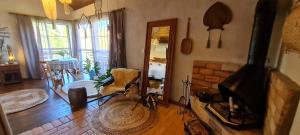 a living room with a fireplace and a chair in it at Chalé Pétala - Vila Monte Cunha in Cunha