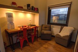 a room with a table and a chair and a window at Cabañas Julián Elías Roja in Puerto Natales