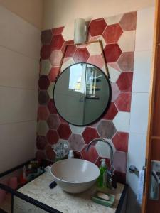 a bathroom with a sink and a mirror at Casa Con Vista al Lago Ypacaraí in San Bernardino +13 photos