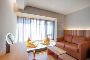 a living room with a couch and a large window at Gion Elite Terrace in Kyoto