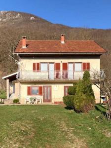 a large house with a balcony on a yard at Secluded apartments Srb, Zagora - 22245 in Srb