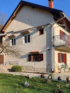 a white house with red shutters on it at Secluded apartments Srb, Zagora - 22245 in Srb +6 photos