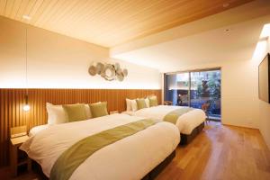 a bedroom with two beds and a window at Gion Elite Terrace in Kyoto