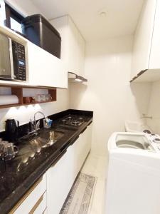 cocina blanca con lavabo y aseo en Intermares, Apartamento Automatizado e Inteligente - Piscina, Elevador, Garagem - Conforto, Paz e Sossego, excelente para descansar, trabalhar ou estudar, en Cabedelo