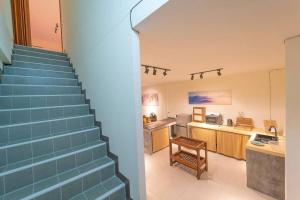 a staircase leading up to a kitchen and a living room at The Town House in Pai
