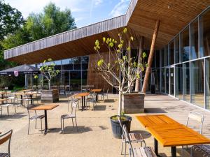 a group of tables and chairs in front of a building at Cottage in Antoing, Hainaut in Antoing