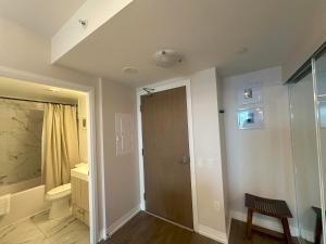 a room with a door and a sink and a bathroom at RivetStays - The Jarvis in Toronto +37 photos