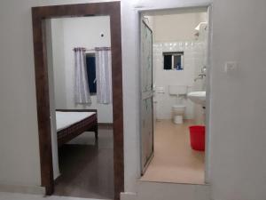 a bathroom with a sink and a toilet and a mirror at Dharmik guest house in Bodh Gaya