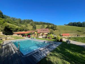 a swimming pool in the yard of a house at Gîte marguerite in Sainte-Marie-aux-Mines