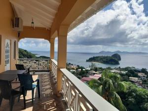 a balcony of a house with a view of the ocean at Windsor Apartment in Kingstown