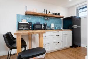 eine Küche mit einer Theke, einer Mikrowelle und einem Kühlschrank in der Unterkunft Be A Nomad - Beach Cottage Oceanfront in Jacksonville Beach