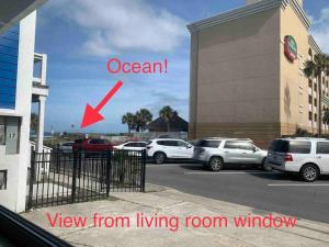 a view of a parking lot with cars parked at Be A Nomad - Beach Cottage Oceanfront in Jacksonville Beach