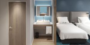 a bathroom with two beds and a sink in it at Holiday Inn Express Xi'an Daxing by IHG in Xi'an