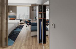 a bedroom with a bed and a living room at Holiday Inn Express Xi'an Daxing by IHG in Xi'an